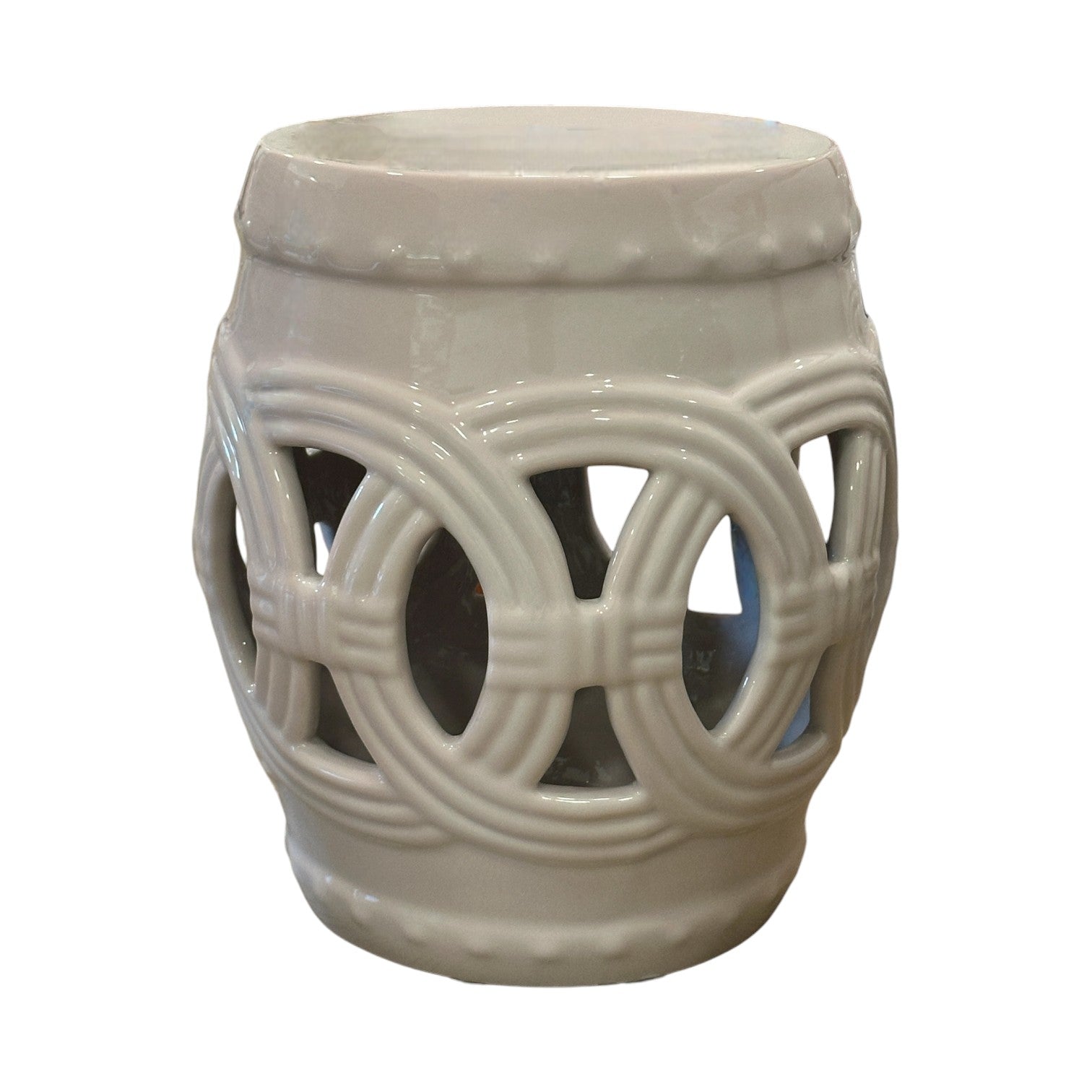 The Fine Porcelain Circle Stool in Flush Pink features a glossy finish and circular cutout patterns, crafted from quality porcelain for lasting beauty.