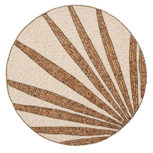 The Kim Seybert Royal Palm Placemat features a sunburst pattern with alternating brown and beige hand-applied beads, making it a perfect tropical accent for vibrant table settings.