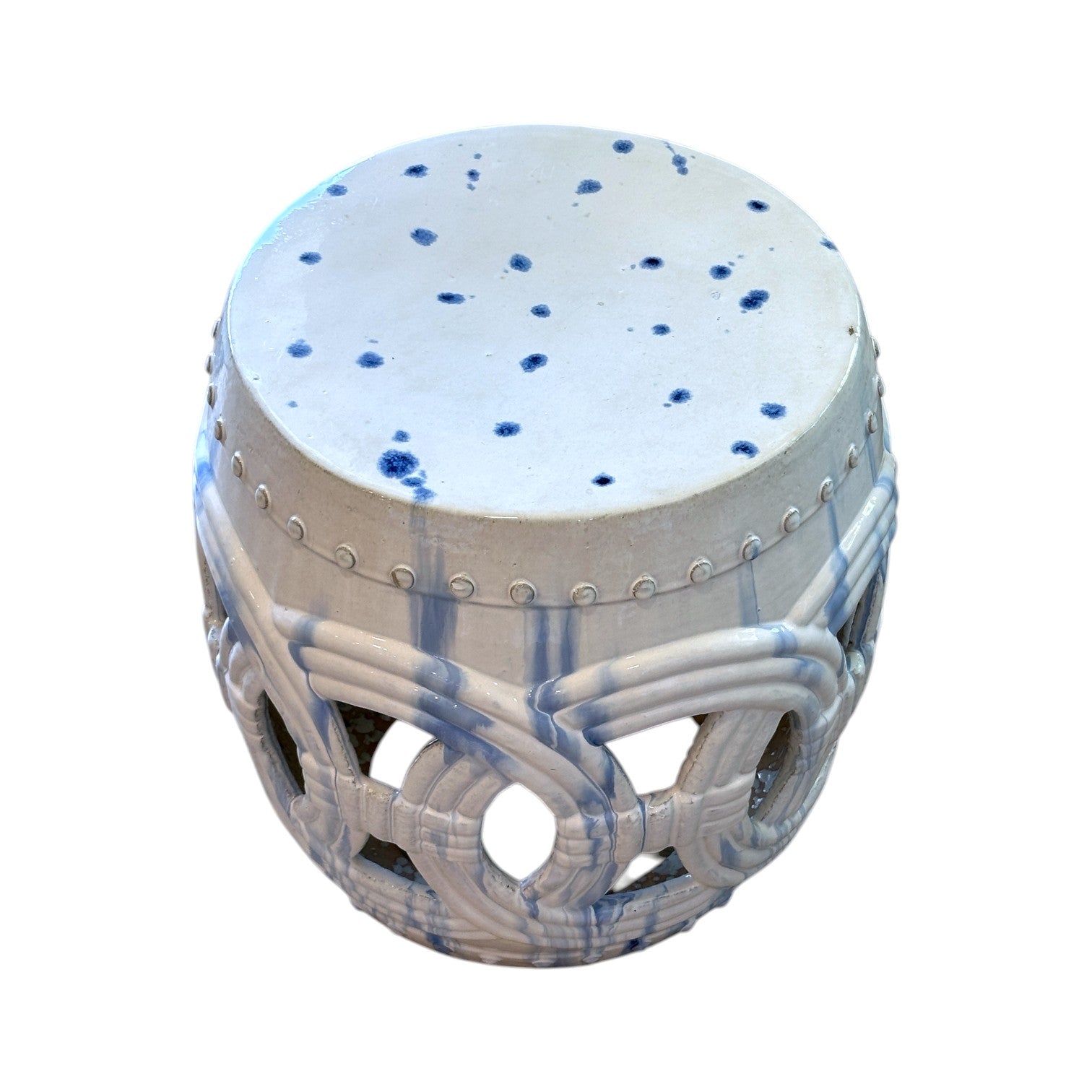 The Large Circle Stool in White and Blue features blue accents, cut-out circular patterns, and a spotted top, creating an antique look inspired by dragon kiln rustic stools.