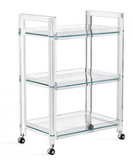 The Ava Acrylic Bar Cart boasts a clear acrylic and glass three-tier rectangular design with four caster wheels, shown on a white background.