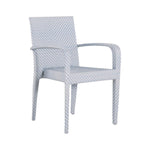 The Bari Stacking Arm Chair in Chambray features light blue and white woven resin wicker, a high back, and slightly curved arms, shown here against a plain white background.
