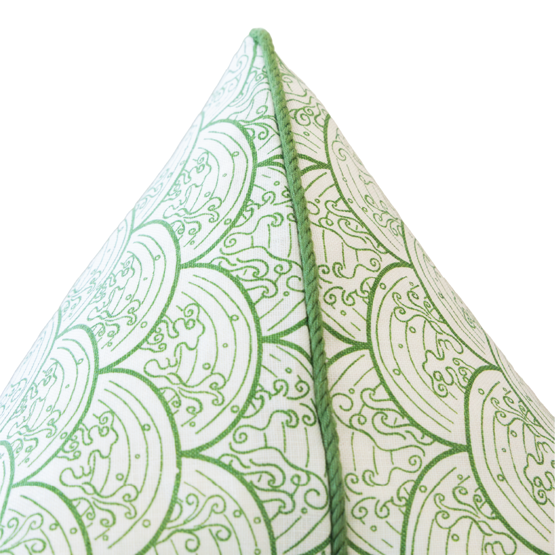 Close-up of the pointed corner of the Wave Grass Pillow, showcasing its green and white circular patterned design against a white background. This custom pillow includes a hidden zipper closure for a seamless look.