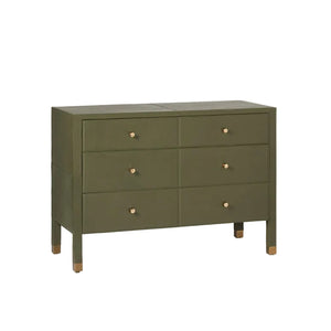 The Conner Dresser is an olive green rectangular dresser with a classic shape, six drawers, gold knobs, and gold-capped legs, shown against a plain white background.