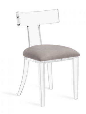 The IH Tristan Dining Chair features a modern design with a clear acrylic frame, curved backrest, and gray velvet upholstered seat. Dimensions: 19" x 22" x 35".