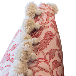 Close-up of the Peacock Garden Lumbar Pillow, showcasing its pink and white floral pattern and cream-colored pom-pom trim along the edge, with a hidden zipper for a seamless look.