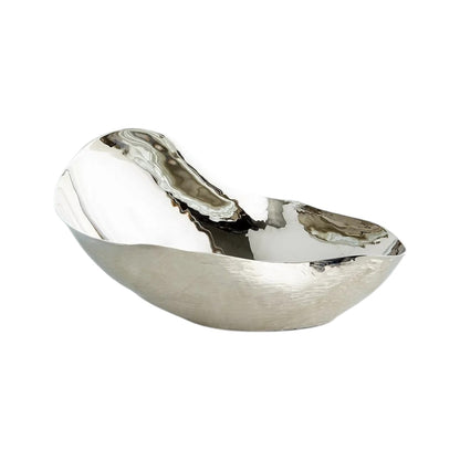 The Freeform Bowl is a reflective, asymmetrical serving bowl made of nickel-plated brass with a textured surface, shown on a white background.