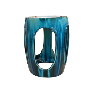 The Green and Turquoise Ming Style Garden Stool, with a glossy glaze and oval cutouts for an antique look inspired by traditional craftsmanship, is shown against a white background.