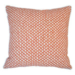 The Mandarin Wicker Outdoor Pillow features an orange and white geometric dot pattern, crafted from premium materials for a luxurious feel. Shown on a plain white background.