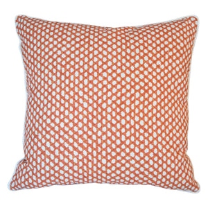 The Mandarin Wicker Outdoor Pillow features an orange and white geometric dot pattern, crafted from premium materials for a luxurious feel. Shown on a plain white background.