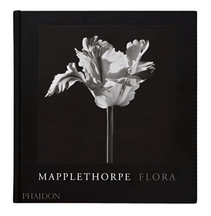 The book cover of "Mapplethorpe Flora" by Phaidon highlights Robert Mapplethorpe's exquisite flower photography, featuring a black-and-white image of a flower with curled petals on a dark background.