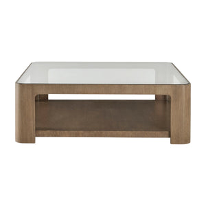The Marin Cocktail Table in Almond features a modern oak veneer, a glass top, and an open lower shelf, shown from the front.