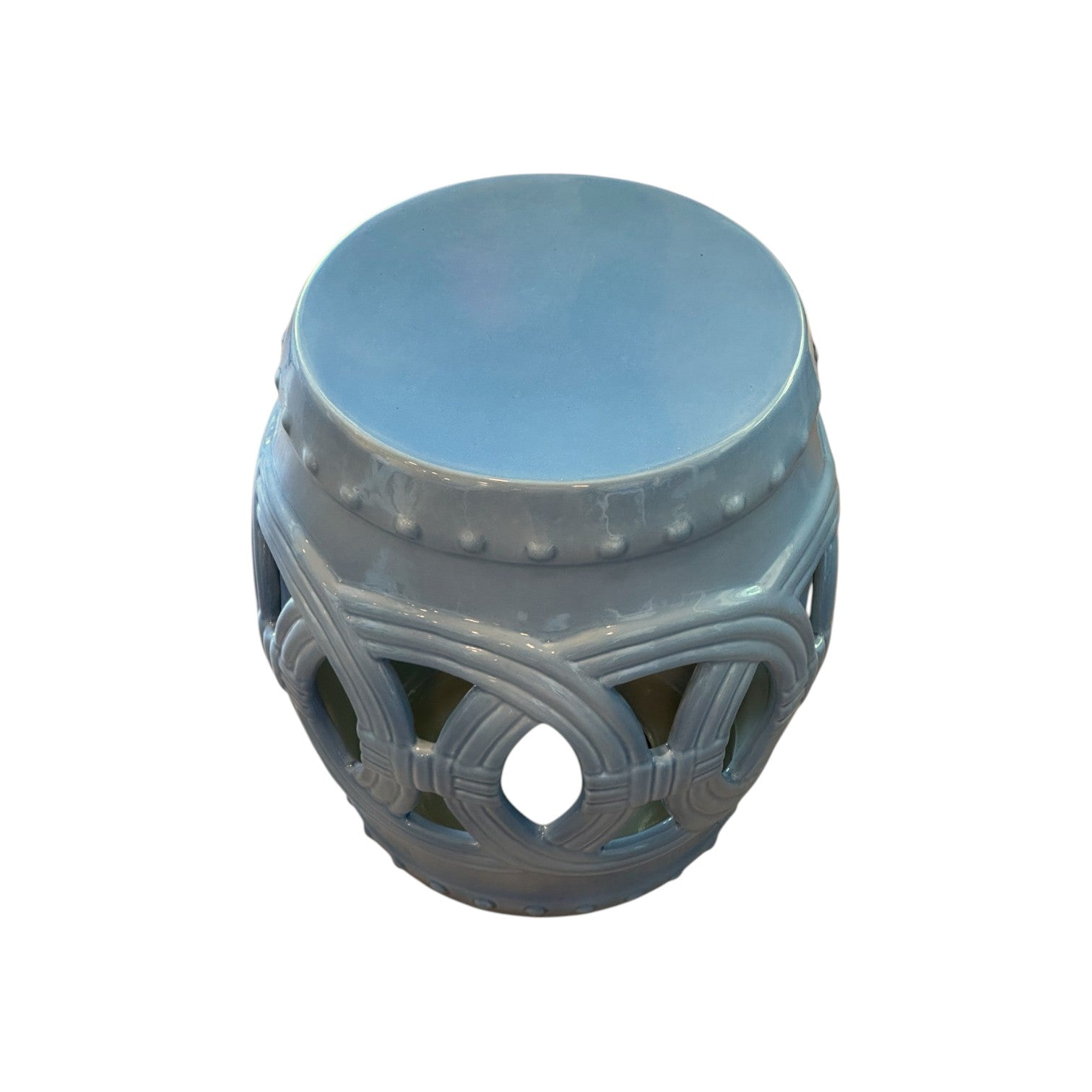 The Mediterranean Blue Circle Stool is a light blue ceramic garden stool featuring a round top, decorative cutout patterns, and small raised dots along the edge for an antique, rustic-inspired look.