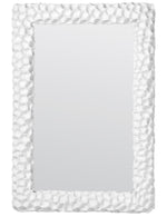 A Dara Coral Mirror, White with a textured, rock-like frame offers a coral-inspired aesthetic.