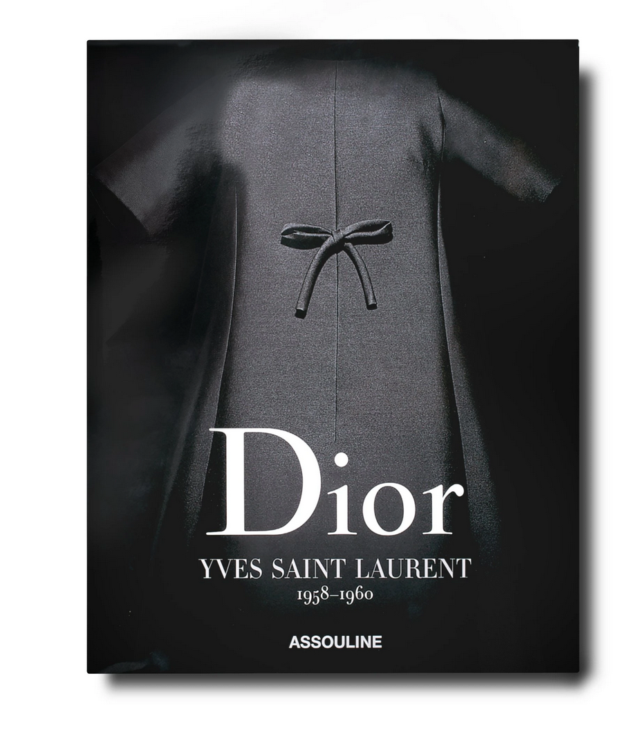 Cover of the book "Dior: Yves Saint Laurent" by Assouline, showcasing a haute couture black dress with a bow on the front.