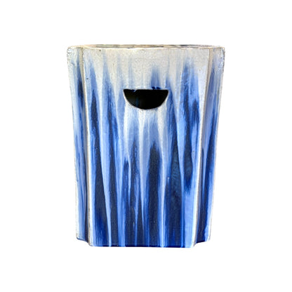 The White and Blue Square Garden Stool features an antique-style blue and white vertical striped pattern with a rounded rectangular cutout handle, adding rustic charm to any space.