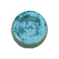 The Mint Circle Garden Stool features a round ceramic form with a mottled blue and green glazed top, light blue-green sides, and an antique finish reminiscent of dragon kiln pieces, displayed against a white background.