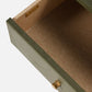 The Conner Dresser features an empty drawer with a green exterior, beige fabric interior, contrast stitching, and gold handle and nameplate.