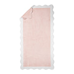 The Neptune Pool Towel in rectangular pink Cairo cotton with a scallop edge is displayed flat, with one corner partially folded over.