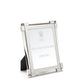 Silver, tarnish-resistant picture frame from the William Yeoward Crystal Classic Clear Frame Collection featuring nickel-plated details and a black backing, designed to stand upright. It gracefully holds an insert labeled "William Yeoward Crystal.