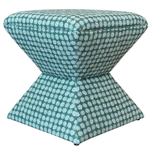 The Hamilton Outdoor Ottoman in Boheme Green features a small hourglass shape with teal fabric and a white circular geometric pattern, making it a chic accent to enhance your patio decor.