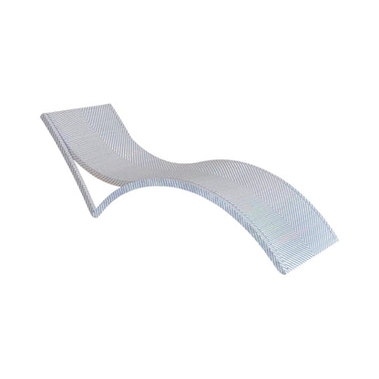 The Bari Stacking Chaise Lounge in Chambray features a modern curved design with light-colored resin wicker, ideal for outdoor relaxation and shown against a white background.