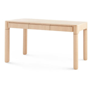 The Nolan Desk is a rectangular light wood desk made from European white oak veneer, featuring rounded legs, a single front drawer, and a subtle chevron wood grain, shown on a white background.