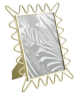 The Ric Rac Picture Frame, featuring a brass frame with a wavy gold border, elegantly displays a black-and-white image of a zebra—perfect for enhancing your collection of family photos.