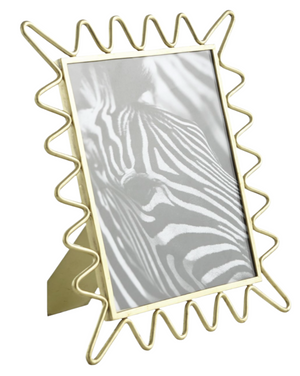 The Ric Rac Picture Frame, featuring a brass frame with a wavy gold border, elegantly displays a black-and-white image of a zebra—perfect for enhancing your collection of family photos.