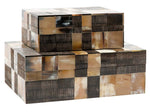 Three rectangular boxes of varying sizes are stacked on top of each other. The Whelan Mixed Horn Box, Large features a hingeless lift-top, and each box has a checkered pattern made of earth-toned tiles.