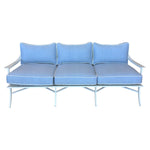 The Haret Outdoor Sofa, a three-seater from our metal outdoor collection, features a white frame with light blue cushions and white piping, shown against a plain white background.