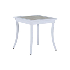 The Bermuda Aluminum End Table is a square white outdoor table with slightly curved wrought aluminum legs and a light-colored tabletop, pictured against a plain white background.