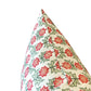 The image shows the corner of the Akhil Azalea Outdoor Pillow, featuring a weather-resistant design with a red and green floral pattern on a white background, photographed against a plain white backdrop.