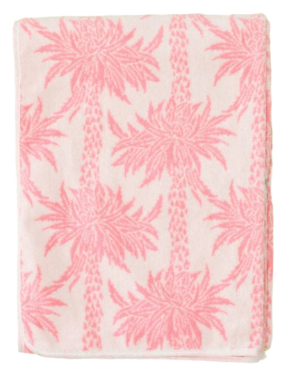 The Weezie Towels x Meg Braff Pool Lounge Cover features a pink pattern with palm trees on a light background, capturing Palm Beach elegance.