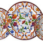 Three decorative plates from the Mario Luca Giusti Pancale White Collection feature colorful floral and butterfly patterns that beautifully blend traditional elegance with modern shapes, echoing Mario Luca Giusti's aesthetic research.