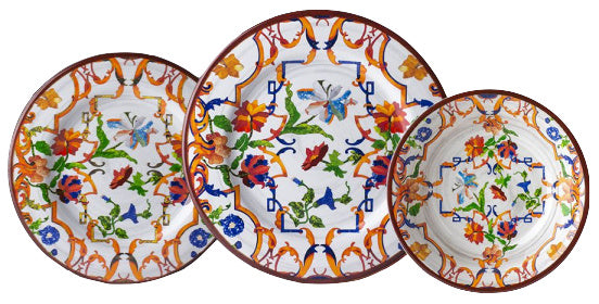 Three decorative plates from the Mario Luca Giusti Pancale White Collection feature colorful floral and butterfly patterns that beautifully blend traditional elegance with modern shapes, echoing Mario Luca Giusti's aesthetic research.