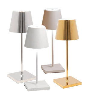 Four modern, dimmable Zafferano Poldina Pro Mini Table Lamps with conical shades and square bases, available in silver, white, beige, and gold finishes. Enjoy the convenience of cordless illumination with built-in rechargeable batteries.