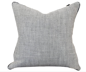 A custom-made Kumano Weave Maracana Pom Stripe Pillow featuring a black and white checkered pattern on a white background. Crafted with the finest materials, it boasts a textured appearance that reflects special attention to detail.