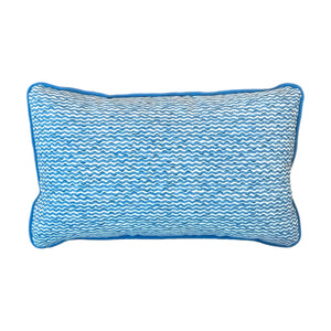 The Popple Blue Outdoor Lumbar Pillow features a blue and white wavy pattern with blue piping along the edges, displayed on a plain white background.