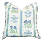 The Folk Floral Pillow is a square throw pillow with a white background, featuring blue and green floral and stripe patterns. This custom pillow is finished with a hidden zipper closure for a sleek look.