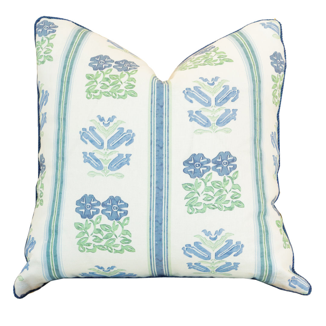 The Folk Floral Pillow is a square throw pillow with a white background, featuring blue and green floral and stripe patterns. This custom pillow is finished with a hidden zipper closure for a sleek look.