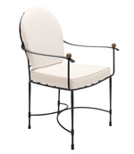 The Amalfi Round Back Armchair has a powder-coated steel frame, rounded back, white cushions, and brass-accented armrests.