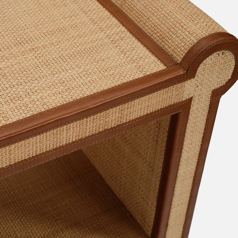 Close-up of the Small Matthew Console, highlighting its detailed craftsmanship with woven rattan and full-grain leather trim on the uniquely shaped arm and seat.