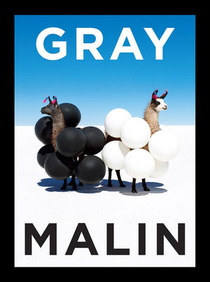 Two llamas decorated with black and white balloons stand on a white salt flat under a clear blue sky. This vibrant photography piece by fine art photographer Gray Malin, titled "Gray Malin: The Essential Collection," features the text "GRAY MALIN" displayed at the top and bottom of the image.