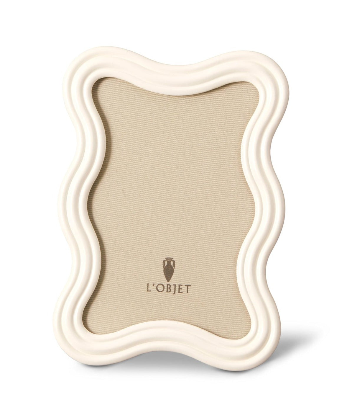 The **L'Objet White Ripple Enamel Frame Collection** is a wavy-edged, off-white enamel photo frame with a blank beige interior and the "L'Objet" logo at the bottom center, exuding a modernist 1970s charm.