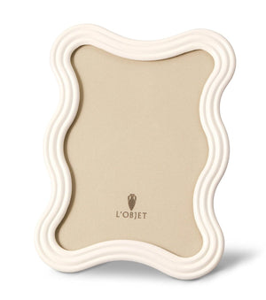 A L'Objet White Ripple Enamel Frame Collection frame with a beige background and the brand name "L'OBJET" printed at the bottom center, reminiscent of modernist 1970s design.