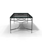 The Amalfi Glass Top Cocktail Table features a hand-forged steel frame and tempered glass, shown from one end casting a shadow on a white background.