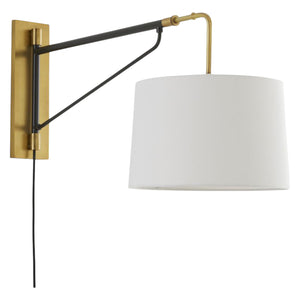 The Anthony Sconce Antique Brass is a wall-mounted swing arm lamp with a brass and black frame, white drum shade, and visible black cord—perfect as an adjustable bedside reading light.