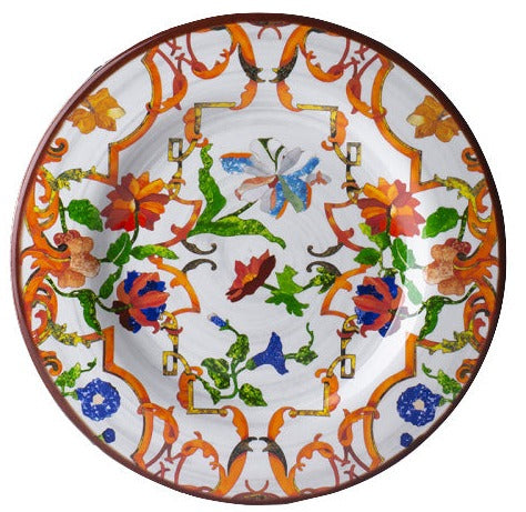 The Mario Luca Giusti Pancale White Collection showcases a decorative ceramic plate adorned with a vibrant floral pattern in shades of orange, green, blue, and red on a white background.