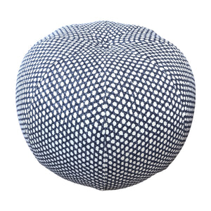 Seabrook Outdoor Ottoman in Wicker Outwick Royal Blue, featuring a round shape and a navy blue and white geometric pattern, shown against a white background.