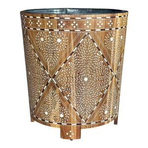 The Large Wood and Bone Planter features elegant white bone inlay with floral and geometric patterns, a cylindrical design, and short legs.